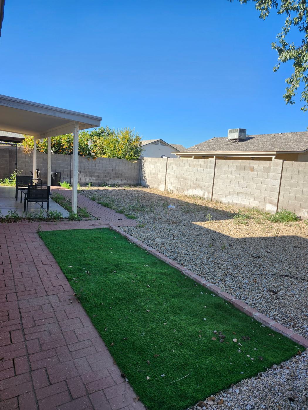 Backyard Turf and Rock Cleanup before service