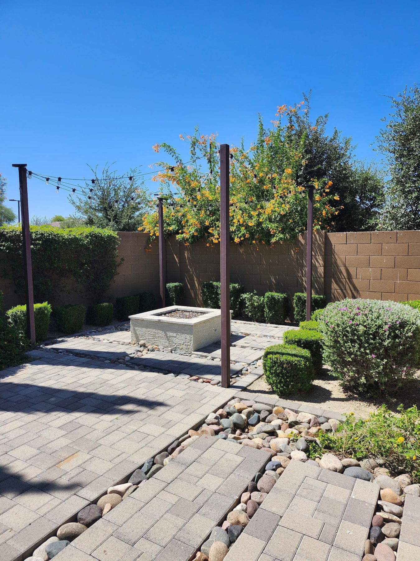 Maintained West Valley residential landscape with shrubs, flowers, and patio
